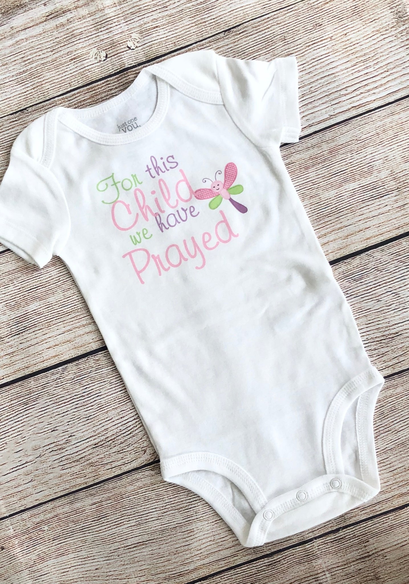 For this child we have clearance prayed onesie